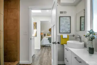 Enter this wonderful MIL (or AirBNB/rental) and pass through a room with a sink and plenty of space to be used as a bedroom, playroom, or craft space. You'll arrive here -- in a spacious bath with large walk-in shower and lovely finishes.