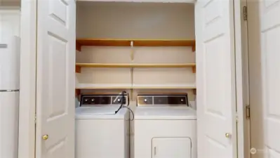The laundry closet sits directly across from the half-bath.