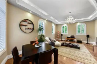 Office or media room with updated new crown moldings around arch windows, shutters, and a tray ceiling.