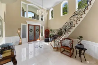 High ceiling, arch windows, Swarovski crystal chandelier, wrought iron staircase.