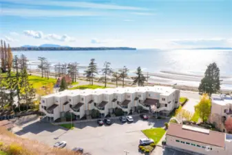 End unit on the far right corner, occupying 2nd and 3rd floors. Unit has windows on three sides for enjoying the the westerly salt water and sunset views.