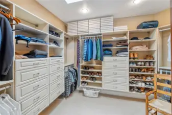 Roomy walk-in closet in the Primary Suite with California Closet systems installed.