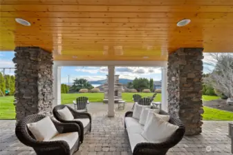 On the lower level, a large covered paver patio - see the stacked rock gas fireplace just beyond.