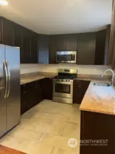 Spacious kitchen with granite counters and stainless steel appliances.