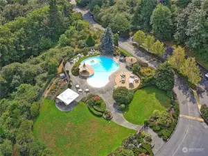 Beautifully landscaped pool and entertainment area. Bathrooms, lounge and dining furnishings, pool toys, party tent & BBQ grill. Community garden "pea patch" with garden shed and personal garden plots.
