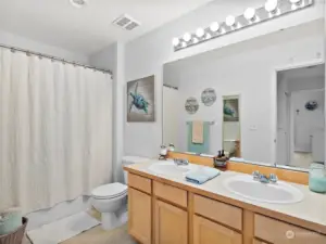 Upstairs is a full bathroom with a tub/shower enclosure and dual sinks.