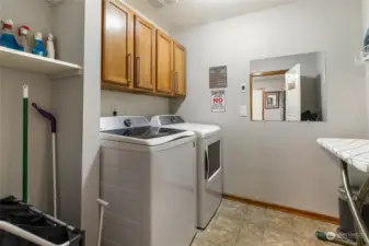 Laundry room with newer washer/dryer and additional storage space.