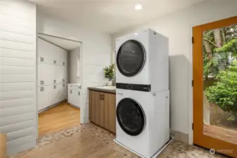 A large laundry room with sink can be accessed from the back yard, garage or side door