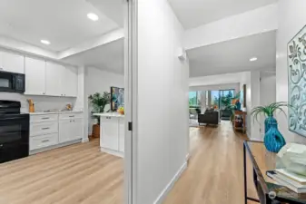 Just as you walk in the door, the home shines with all the upgrades. Look how fresh this is with the new kitchen on the left, living room ahead of you and the enclosed deck. To the right are the 2 bedrooms, baths and W/D.