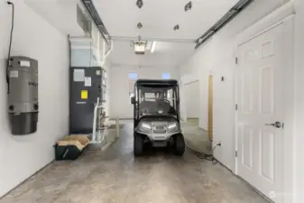 Golf cart area in garage with separate entrance and 1/2 bath