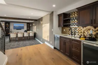 Wet bar off the rec room with built-in cabinetry, drink fridge & Bosch dishwasher.