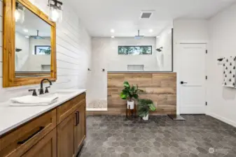 Beautifully designed primary bathroom en suite with large shower, 2 sink vanity and walk-in closet.
