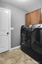 Laundry Room included with almost new Washer & Dryer  - Leads to the Garage