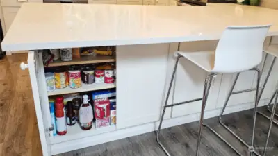 Island has pantry cabinets that has amazing storage, entire length of the island.