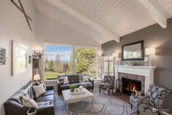 Warm and inviting main floor living room with captivating mountain views.