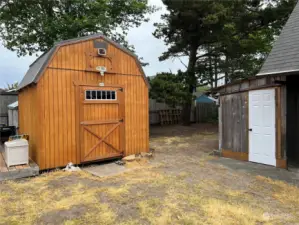 Large storage shed and shop in the side yard.