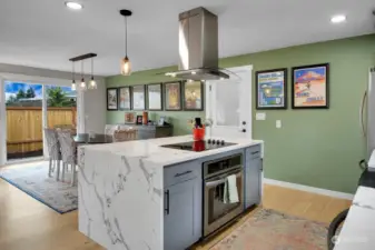 Quarts Countertops And Waterfall Island.  Wall Oven, Flat Cooktop, High End Hood.  Lots of Cabinet And Storage Space In Island.