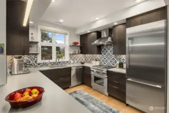 Stainless Thermadore appliances and stylish backspash create a beautiful, fun space to cook.