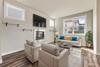 Custom gas fireplace with a large window for ample natural light in your living room! (Virtual Staging)
