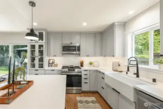 Light and Bright Kitchen makes entertaining fun.  Enjoy your farmhouse sink with touchless faucet, gas range, stainless suite, and storage solutions.