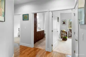 Hallway with linen closet to the right leads to two additional bedrooms and a full bath. All on the opposite side of the home from the primary bedroom.