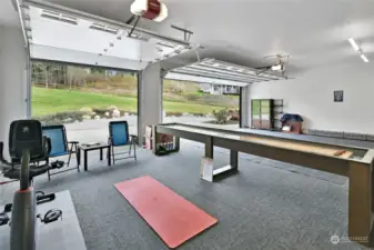 Homeowner uses 3rd bay for a workout and gaming area.