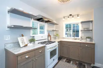 floating shelves and meticulously designed cabinetry provide ample room in this 1920's waterfront bungalow