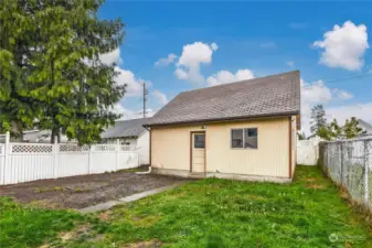 fully fenced and spacious backyard with access to double garage