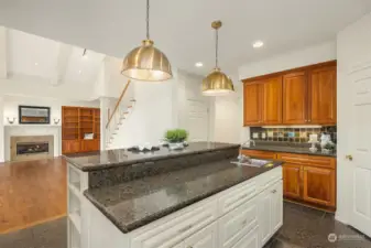 Island features a work sink and cabinets.