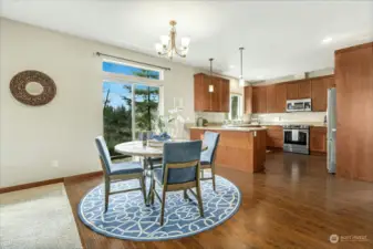 Open & bright dining and kitchen area w/ views.