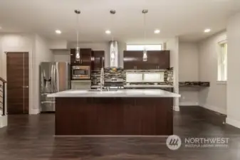 A well-designed chef's kitchen featuring high-quality appliances, ample counter space, and a functional layout.