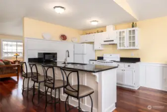 Eat-in kitchen with granite countertops, open to dining and bonus space, perfect for entertaining!