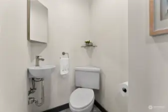 This lovely powder room is conveniently located off the hallway leading to the primary suite.