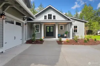 A striking NW Craftsman exterior welcomes you with a 3-car attached garage and beautiful landscaping.