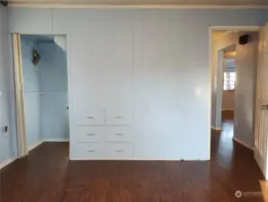 Bedroom on main level with a closet on side and built ins