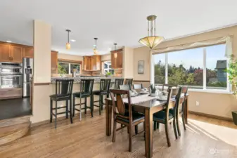 Dining room with beautiful hardwood floors and big windows for tons of natural light!