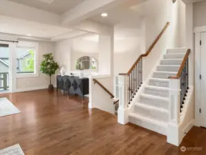 Grand staircase with sophisticated metal railings and new carpet adds to the charm of the great room.