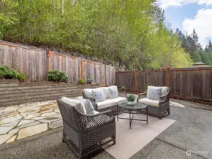 The tranquil outdoor space of this cozy and low-maintenance backyard is ideal for BBQs and summer entertainment