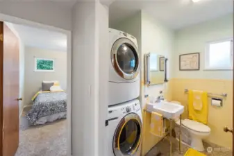Convenient bathroom with built-in washer/dryer and walk-in shower.