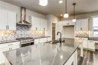 Kitchen has outstanding upgrades, a super island, walk-in pantry & built-in office  area.