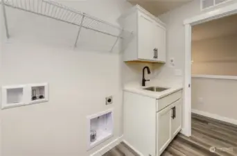 Large laundry room with deep sink on upper level.