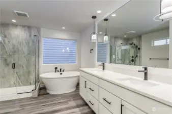 Primary ensuite bath with soaking tub, dual sinks and private water closet.