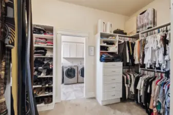 Primary Suite closet with lots of storage options & organizers- walk right through from the primary bathroom through the closet & into the main floor laundry room!