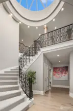 Imposing rounded staircase from upper to lower level