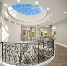 Rod iron railings frame the rounded staircase
