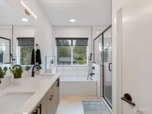 Luxurious 5-piece bathroom features a massive custom shower & dual vanities.