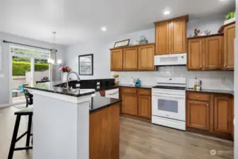 Beautifully updated, spacious kitchen with new appliances (all stay), granite counters, tiled backsplash, wine fridge, new fixtures, flooring and more!