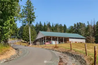 Driving up the over a mile of paved driveway takes you past the barn that has a heated tac kroom, hayloft, shaving storage, covered riding arena & up to 6 stalls with pasture access.