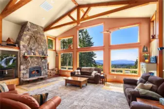 Main home living space with high ceilings, hardwoods, views & more. The home features timber milled from the property throughout.