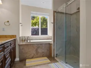 Primary ensuite with a walk-in shower, soaking tub and 2 sinks.